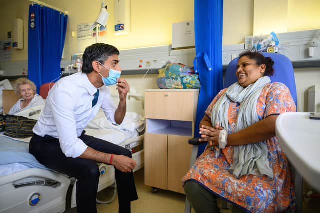 Prime Minister Rishi Sunak speaks with patient Sreeja Gopalan during a visit to Croydon University Hospital, south London on Friday.Leon Neal/PA Wire