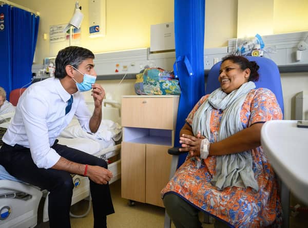 Prime Minister Rishi Sunak speaks with patient Sreeja Gopalan during a visit to Croydon University Hospital, south London on Friday.Leon Neal/PA Wire