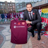 Hearts goalkeeper Craig Gordon with the tributes to Marius Zaliukas outside Tynecastle.