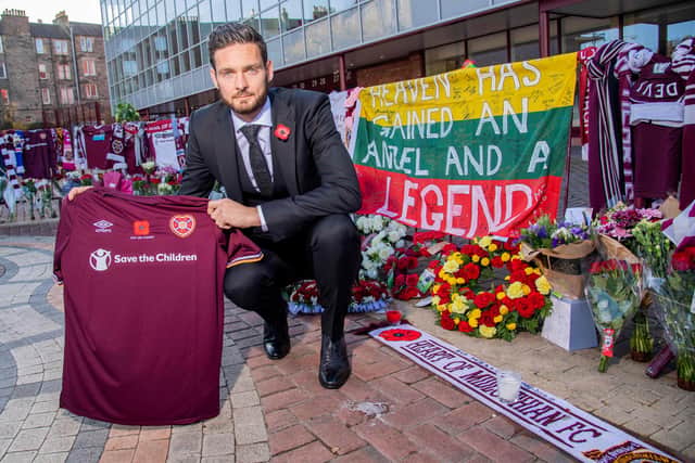 Hearts goalkeeper Craig Gordon with the tributes to Marius Zaliukas outside Tynecastle.
