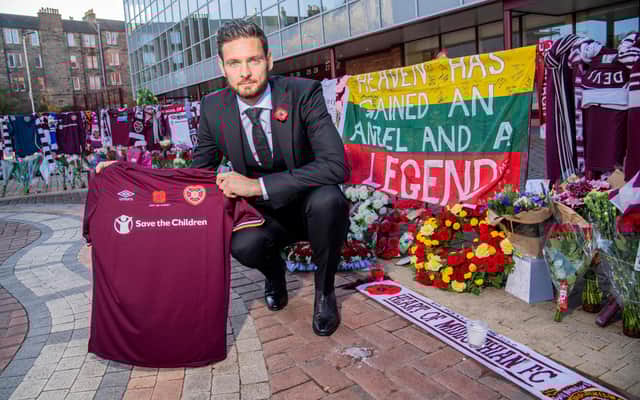 Hearts goalkeeper Craig Gordon with the tributes to Marius Zaliukas outside Tynecastle.