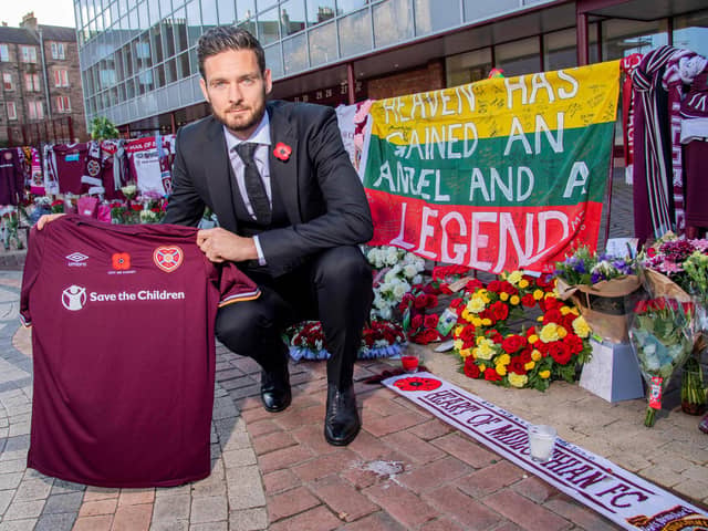 Hearts goalkeeper Craig Gordon with the tributes to Marius Zaliukas outside Tynecastle.