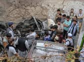 Afghan residents and family members of the victims gather next to a damaged vehicle inside a house, after a US drone airstrike in Kabul. Picture: Wakil Kohsar/AFP via Getty Images