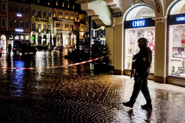 Police officers guard the scene of an incident in Trier, Germany, Tuesday, Dec. 1, 2020.  AP Photo/Michael Probst