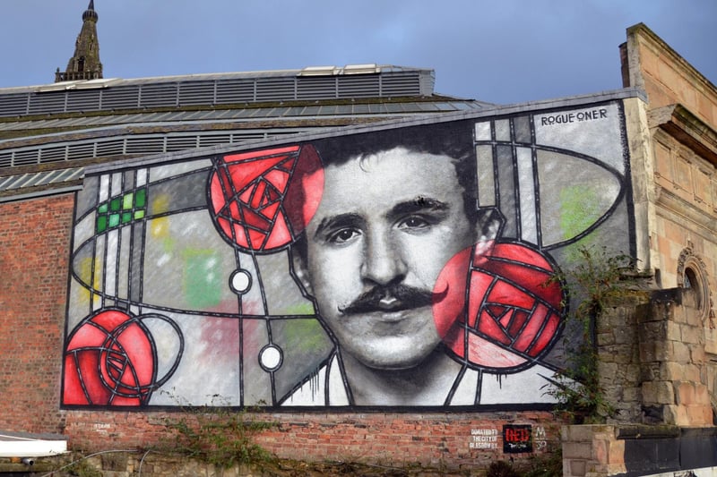 The mural was made by Rogue One, a local street artist, in collaboration with Art Pistol Projects. It depicts Mackintosh in a monochromatic style looking through a stained glass window with the architect’s iconic Glasgow Rose motif. It overlooks Glasgow’s Clutha Bar and marked the 150th anniversary of Mackintosh’s birth in 2018.