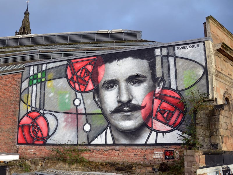 The mural was made by Rogue One, a local street artist, in collaboration with Art Pistol Projects. It depicts Mackintosh in a monochromatic style looking through a stained glass window with the architect’s iconic Glasgow Rose motif. It overlooks Glasgow’s Clutha Bar and marked the 150th anniversary of Mackintosh’s birth in 2018.