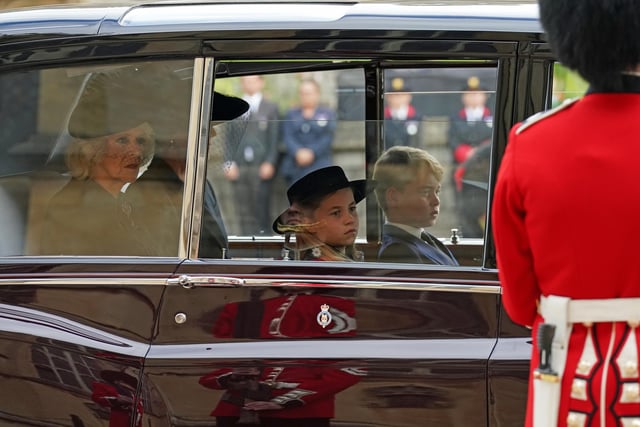 (left to right) The Queen Consort, the Princess of Wales, Prince George and Princess Charlotte follow the State Hearse carrying the coffin of Queen Elizabeth II, draped in the Royal Standard with the Imperial State Crown and the Sovereign's Orb and Sceptre, as it arrives at the Committal Service held at St George's Chapel in Windsor Castle, Berkshire. Picture date: Monday September 19, 2022.