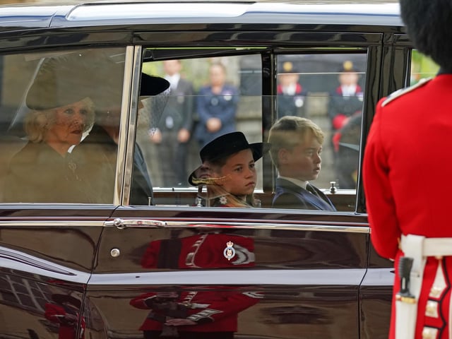 (left to right) The Queen Consort, the Princess of Wales, Prince George and Princess Charlotte follow the State Hearse carrying the coffin of Queen Elizabeth II, draped in the Royal Standard with the Imperial State Crown and the Sovereign's Orb and Sceptre, as it arrives at the Committal Service held at St George's Chapel in Windsor Castle, Berkshire. Picture date: Monday September 19, 2022.