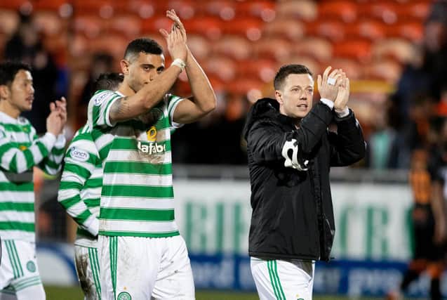 Celtic's Giorgis Giakoumakis and Callum McGregor applaud the fans following the 3-0 Scottish Cup quarter final victory away to Dundee United which  has exalted the double-scoring Greek striker and his now 30 domestic games without a defeat team. (Photo by Craig Williamson / SNS Group)
