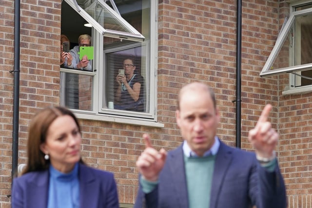 People look out of the window as the Duke and Duchess of Cambridge.