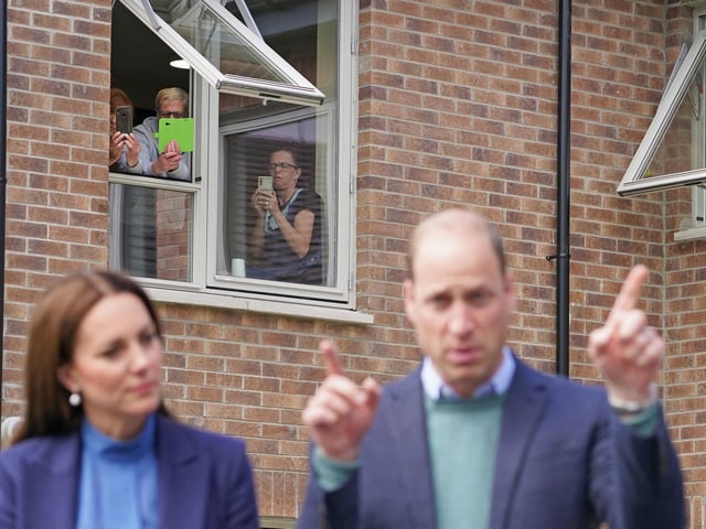 People look out of the window as the Duke and Duchess of Cambridge.
