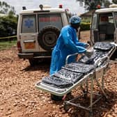 Red Cross workers clean ambulances prior to transporting Ebola victims to a hospital on October 13, 2022 in Mubende, Uganda