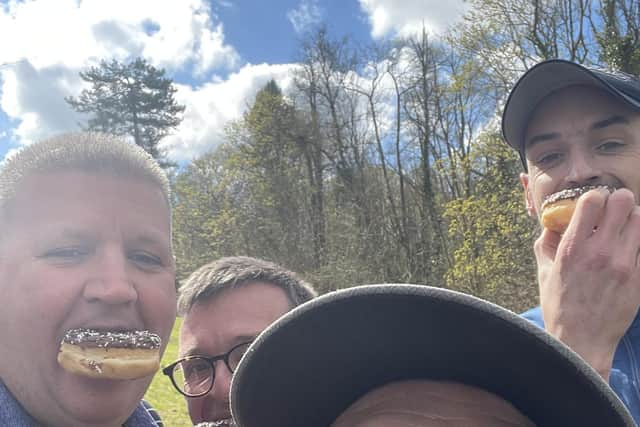 Fraser Jervis, left, tucks into a donut with some of his team-mates for the Dispatch Trophy.