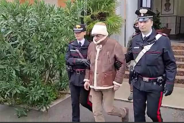 The transfer of Italy's top wanted mafia boss, Matteo Messina Denaro (centre) from the Carabinieri police station of San Lorenzo in Palermo, following his arrest in his native Sicily in January. Picture: Italian Carabinieri Press Office/AFP via Getty Images