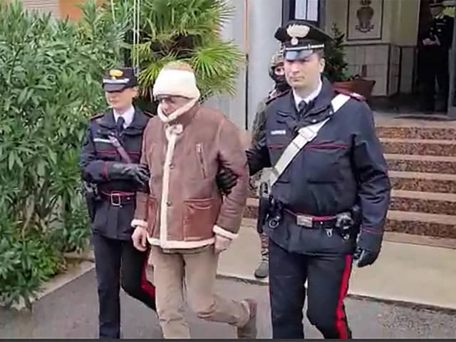 The transfer of Italy's top wanted mafia boss, Matteo Messina Denaro (centre) from the Carabinieri police station of San Lorenzo in Palermo, following his arrest in his native Sicily in January. Picture: Italian Carabinieri Press Office/AFP via Getty Images