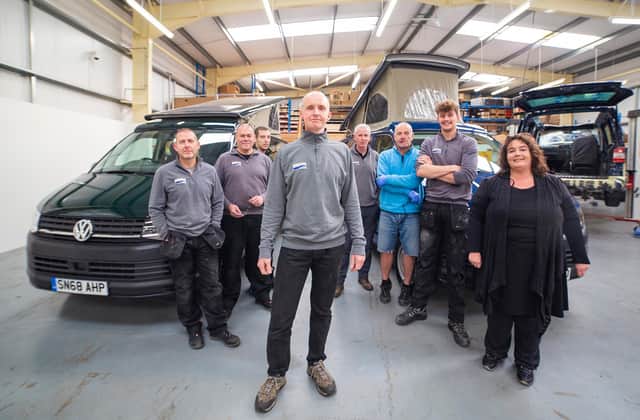 Simon Poole, co-founder of the campervan firm, and team. Picture: contributed.