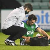 Hibs midfielder Joe Newell receives treatment for his injured shoulder during the match against Hamilton on Friday. Photo by Craig Foy / SNS Group