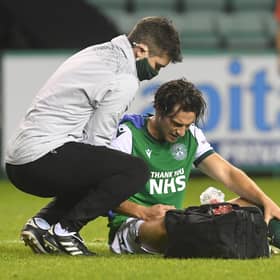 Hibs midfielder Joe Newell receives treatment for his injured shoulder during the match against Hamilton on Friday. Photo by Craig Foy / SNS Group