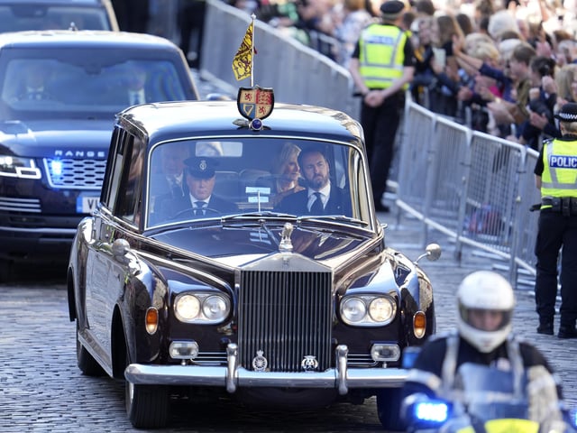 King Charles III and the Queen Consort are driven along the Royal Mile ahead of the Procession of Queen Elizabeth's coffin from the Palace of Holyroodhouse to St Giles' Cathedral, Edinburgh. Picture date: Monday September 12, 2022.
