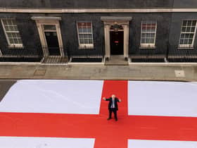 Prime Minister Boris Johnson poses for a photograph outside 10 Downing Street with a giant St George's flag ahead of the England Quarter Final game against Ukraine. Picture by Simon Dawson / No 10 Downing Street