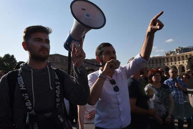 Armenians protest to urge the government to respond to the Azerbaijani military operation launched against the breakaway Nagorno-Karabakh region outside the government building in central Yerevan.