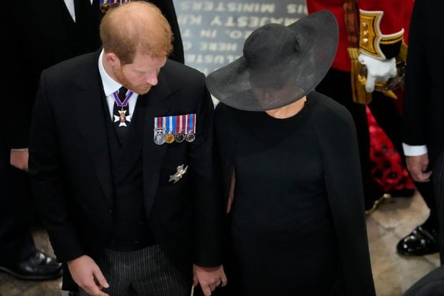 Prince Harry, Duke of Sussex and Meghan, the Duchess of Sussex follow the coffin of Queen Elizabeth II as it is carried out of Westminster Abbey after the State Funeral.