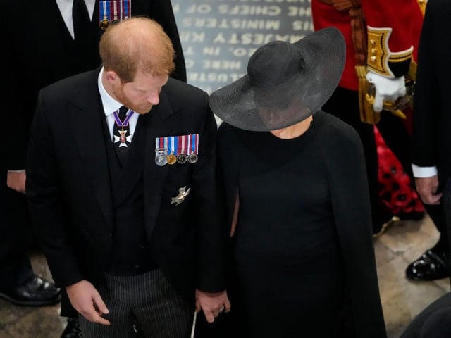Prince Harry, Duke of Sussex and Meghan, the Duchess of Sussex follow the coffin of Queen Elizabeth II as it is carried out of Westminster Abbey after the State Funeral.