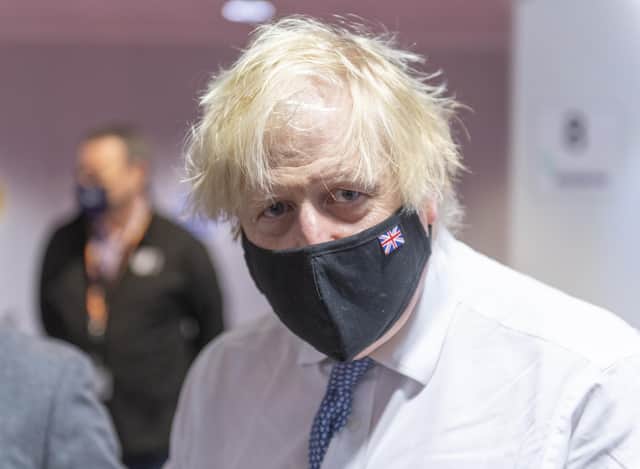 Prime Minister Boris Johnson during a visit to a Covid vaccination centre at the Rainbow Pharmacy in the Open University Campus, Walton Hall, Milton Keynes, Buckinghamshire. Picture date: Wednesday December 29, 2021.