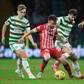 Raith's Aidan Connolly (centre) holds off Celtic's Albian Ajeti during a Premier Sports Cup quarter final match between Celtic and Raith Rovers at Celtic Park, on September 23, 2021, in Glasgow, Scotland.  (Photo by Ross MacDonald / SNS Group)