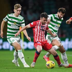 Raith's Aidan Connolly (centre) holds off Celtic's Albian Ajeti during a Premier Sports Cup quarter final match between Celtic and Raith Rovers at Celtic Park, on September 23, 2021, in Glasgow, Scotland.  (Photo by Ross MacDonald / SNS Group)