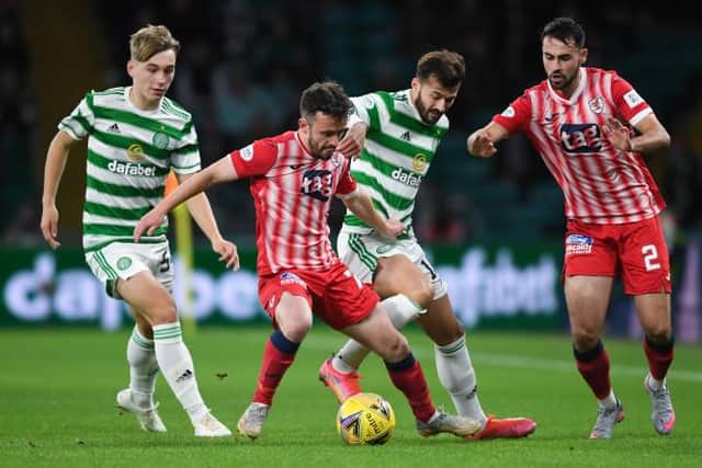 Raith's Aidan Connolly (centre) holds off Celtic's Albian Ajeti during a Premier Sports Cup quarter final match between Celtic and Raith Rovers at Celtic Park, on September 23, 2021, in Glasgow, Scotland. (Photo by Ross MacDonald / SNS Group)