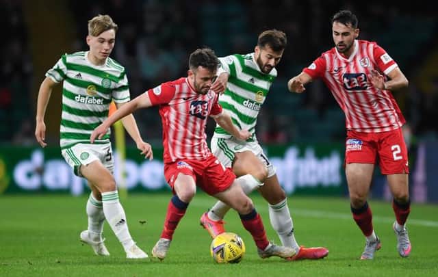 Raith's Aidan Connolly (centre) holds off Celtic's Albian Ajeti during a Premier Sports Cup quarter final match between Celtic and Raith Rovers at Celtic Park, on September 23, 2021, in Glasgow, Scotland.  (Photo by Ross MacDonald / SNS Group)