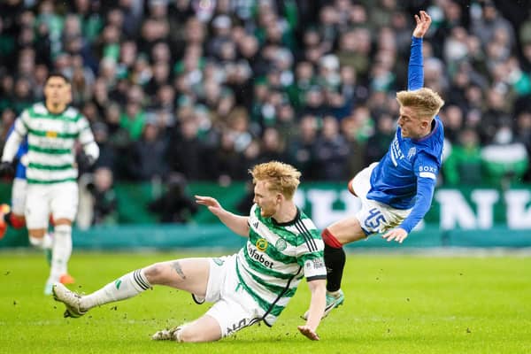GLASGOW, SCOTLAND - DECEMBER 30: Celtic's Liam Scales tackles Rangers' Ross McCausland. he Irishman again stood up in another major occasion and says he is used to the demands required in them. (Photo by Alan Harvey / SNS Group)