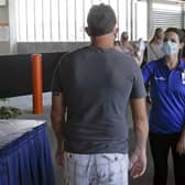 A guest goes through a temperature check designed to spot one symptom of Covid-19 coronavirus infection before entering the Disney Springs shopping, dining and entertainment complex in Lake Buena Vista, Flordia (Picture: John Raoux/AP)