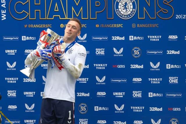 Rangers goalkeeper Allan McGregor gets his gloves on the Premiership trophy at Ibrox at the end of last season. (Photo by Craig Williamson / SNS Group)