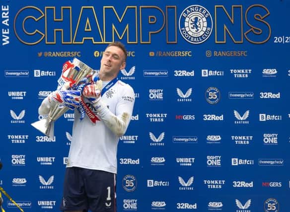 Rangers goalkeeper Allan McGregor gets his gloves on the Premiership trophy at Ibrox at the end of last season. (Photo by Craig Williamson / SNS Group)