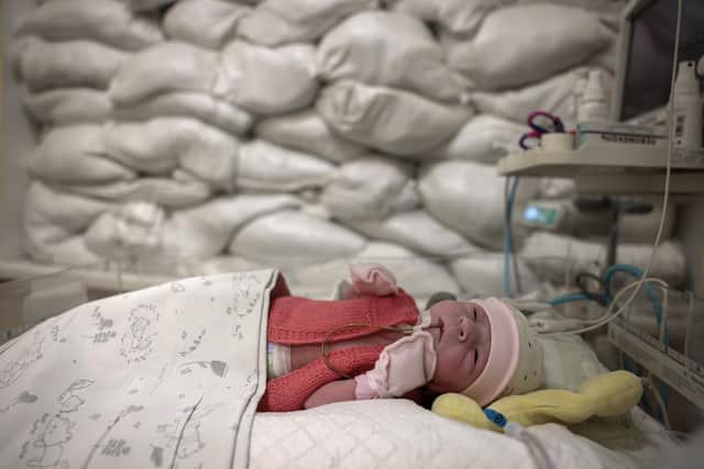 A child rests in a cot beside a window protected by sandbags in an intensive care unit for newborns at Okhmatdyt Hospital, Kyiv, yesterday (Picture: Jeff J Mitchell/Getty Images)