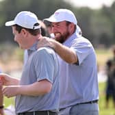 Shane Lowry congratulates Great Britain & Ireland team-mate Bob Macintyre during the inaugural Hero Cup at Abu Dhabi Golf Club in January. Picture: Ross Kinnaird/Getty Images.