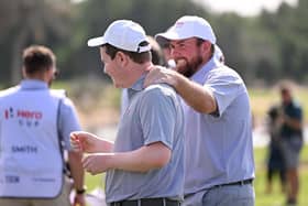 Shane Lowry congratulates Great Britain & Ireland team-mate Bob Macintyre during the inaugural Hero Cup at Abu Dhabi Golf Club in January. Picture: Ross Kinnaird/Getty Images.