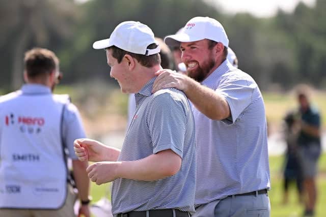 Shane Lowry congratulates Great Britain & Ireland team-mate Bob Macintyre during the inaugural Hero Cup at Abu Dhabi Golf Club in January. Picture: Ross Kinnaird/Getty Images.