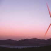 Revolutionary moves: a wind turbine with the Isle of Arran as a backdrop. Smart meters can play an integral part in integrating the intermittent nature of renewable energy sources into our power mix