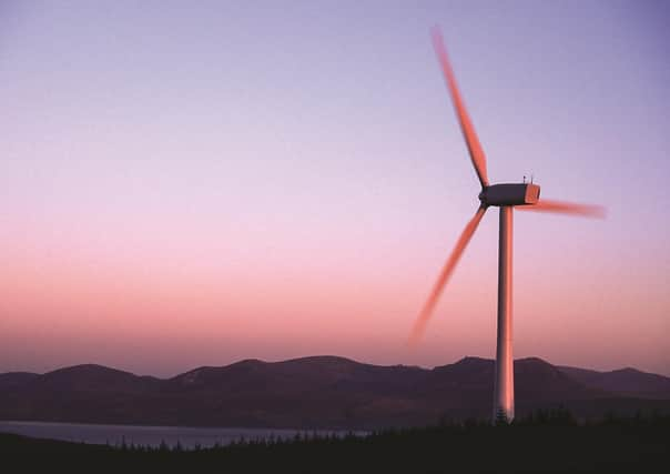 Revolutionary moves: a wind turbine with the Isle of Arran as a backdrop. Smart meters can play an integral part in integrating the intermittent nature of renewable energy sources into our power mix