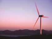 Revolutionary moves: a wind turbine with the Isle of Arran as a backdrop. Smart meters can play an integral part in integrating the intermittent nature of renewable energy sources into our power mix