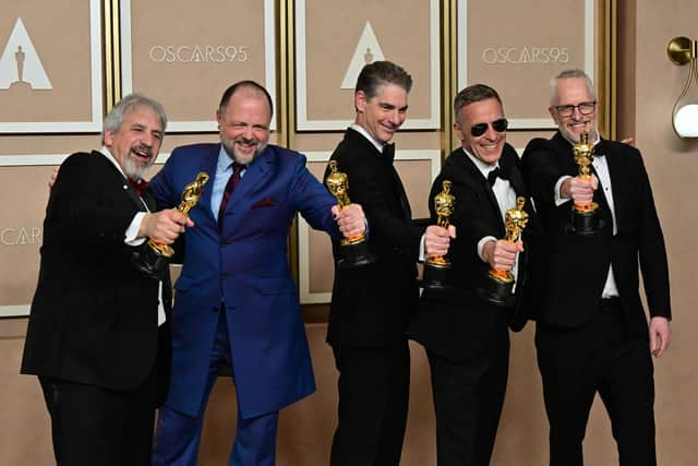 US production sound mixer Mark Wingarten, British sound editor James H Mather, US musical composer Al Nelson, British sound engineer Chris Burdon and British sound engineer Mark Taylorn were honoured with the Oscar for best sound for their work on Top Gun: Maverick. Picture: Frederic J. Brown / AFP