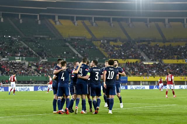 Scotland celebrate after Lyndon Dykes netted from the penalty spot in Vienna.