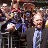 Scotish coach Craig Brown salutes Scotish supporters 10 June at the Stade de France in Saint Denis before the opening ceremony of the 1998 Soccer World Cup between Brazil and Scotland.  (Photo by TOSHIFUMI KITAMURA/AFP via Getty Images)