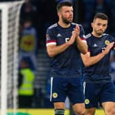 Grant Hanley (L) and John McGinn of Scotland applaud the home support at full time. (Photo by Ewan Bootman / SNS Group)