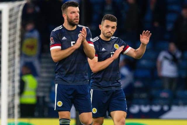 Grant Hanley (L) and John McGinn of Scotland applaud the home support at full time. (Photo by Ewan Bootman / SNS Group)
