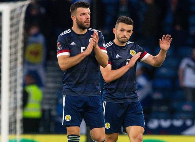Grant Hanley (L) and John McGinn of Scotland applaud the home support at full time. (Photo by Ewan Bootman / SNS Group)