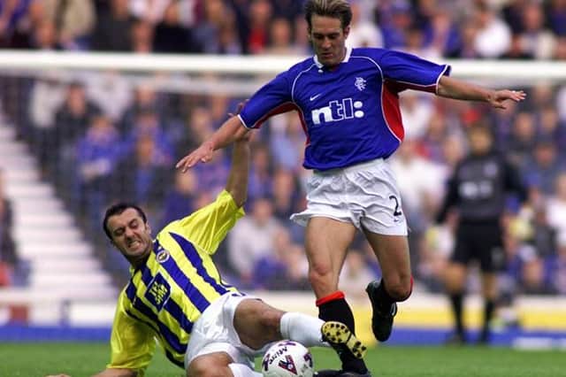 Milan Rapaic (left) steals possession from Rangers midfielder Fernando Ricksen with a well timed tackle in 2001